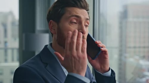 Annoyed Boss Calling Cellphone Gesturing Hand Cityscape Windows Office Closeup