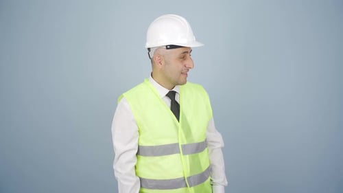Engineer looking at camera in amazement and making a presentation.
