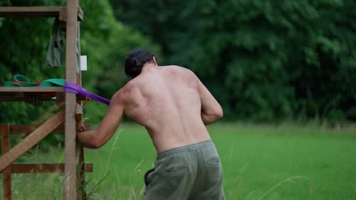 Man Exercising with Resistance Band Outdoors