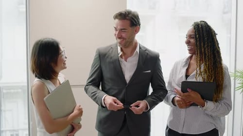 A Diverse Group of Professionals Engaging in Collaborative Office Activities and Talks