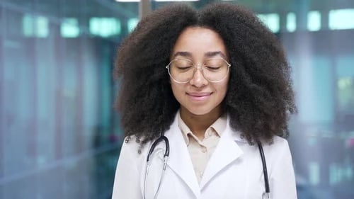 Smiling Woman Doctor in White Coat and Stethoscope