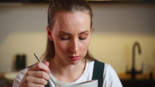 Woman Enjoying a Salad in Her Kitchen