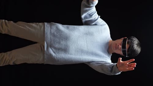 Young Adult Interacting with Virtual Reality Glasses