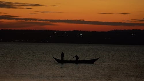 Young Beautiful Girl is Sailing in Boat on Lake and Thoughtfully Looking Into Distance Resting Her