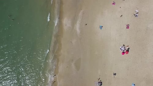 Mediterranean beach during summer with people in the water