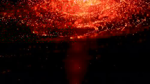 Partículas desde abajo Partículas de polvo anaranjado parpadeando sobre fondo negro.