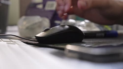 Person using black computer mouse in office