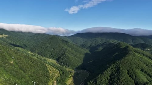 Majestic Mountain Scenery with Floating Clouds