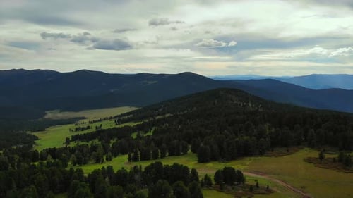 Aerial View of Forested Mountains and Green Valley Media