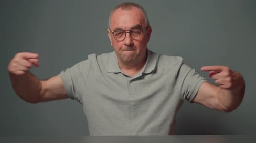 Man Measures Something Small with Fingers Showing Surprise