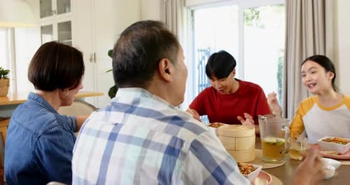 Family Enjoys Lunch Together at Dining Table