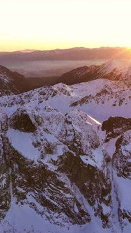 Majestic sunset over the snowy Alps captured in vertical format