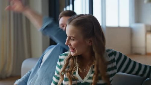 Affectionate Couple Relaxing on Sofa Inside Home