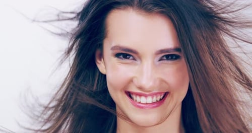 Smiling Woman's Hair Blows in the Wind