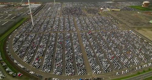 Aerial Top View of New Cars Parking for Sale Stock Lot Row Dealer Inventory Import and Export