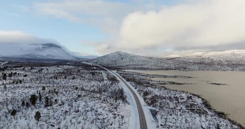 SnowCovered Road Stretching Into Arctic Landscape