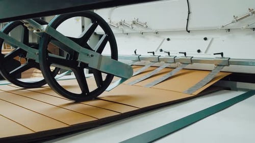 Corrugated Cardboard Sheets are Automatically Transported Along a Conveyor Belt for Further Storage