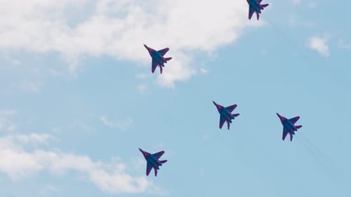 Planes Fly in Formation Against a Blue Sky