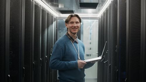 Portrait of Technician Standing with Laptop in Data Center Facility