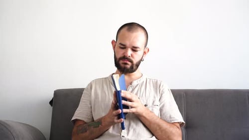 Man Reading a Book on the Couch