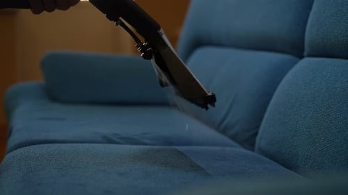 Apparatus Cleans Stains on Blue Couch