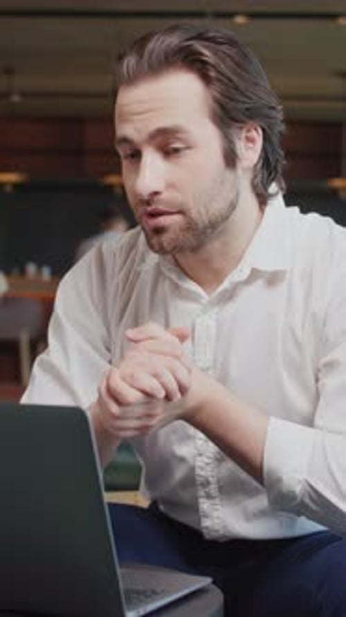 Portrait Attractive Young Business Man Talking in Video Conference Using Laptop Sitting in Cafe
