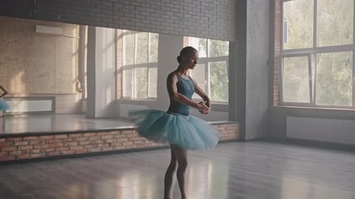Young Woman Dancing Ballet in Studio