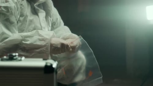 Researcher Placing Object in Evidence Bag