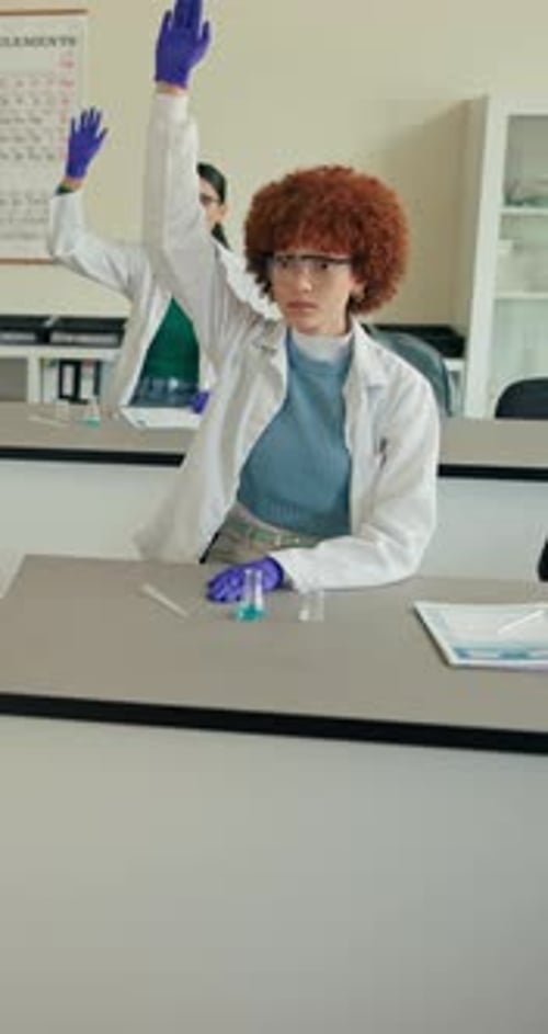 Student in Science Class Raises Hand to Answer