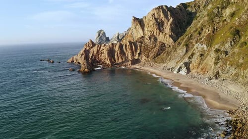 Aerial View of Green Island with Mountain Crag Rocky Cliffs Surrounded Stormy Atlantic Ocean with