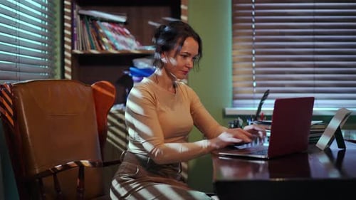 A Young Professional is Effectively Working on Their Laptop in a Modern Office Space