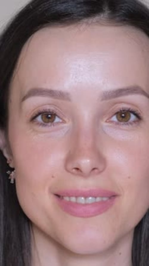Portrait of a Beautiful Young Brunette Woman Looking at the Camera and Smiling Vertical Video