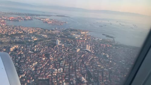 The Plane Descends Over the Port Town View From the Plane From the Porthole