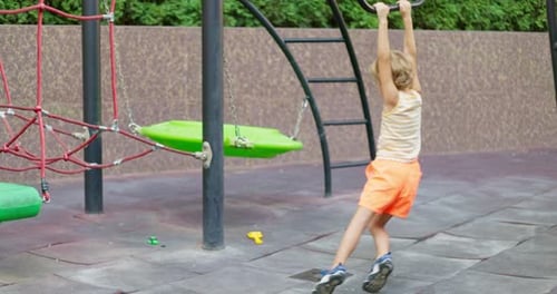 Child Playing on Outdoor Playground Equipment