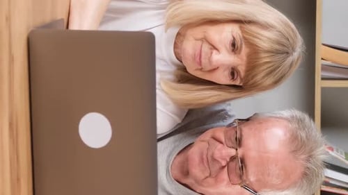 Elderly Couple Looking at Laptop Computer Together