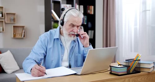 Mature Man Working on Laptop in Home Office
