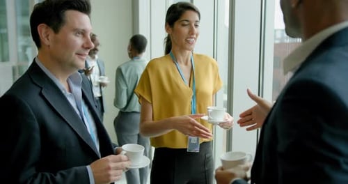 Business Professionals Networking with Tea at Conference