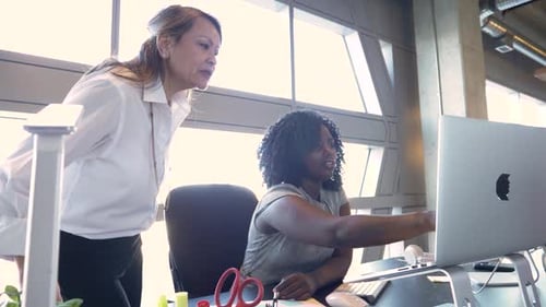 Businesswomen at office desk in a multiracial meeting discussing planning