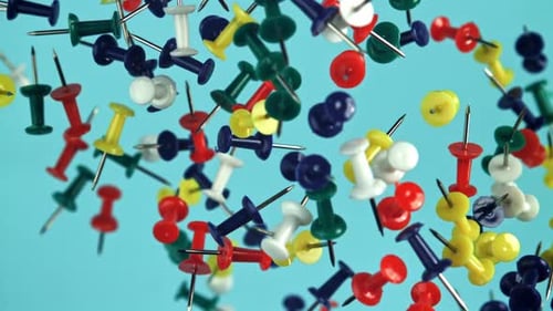 Colorful Thumbtacks Floating on a Blue Background