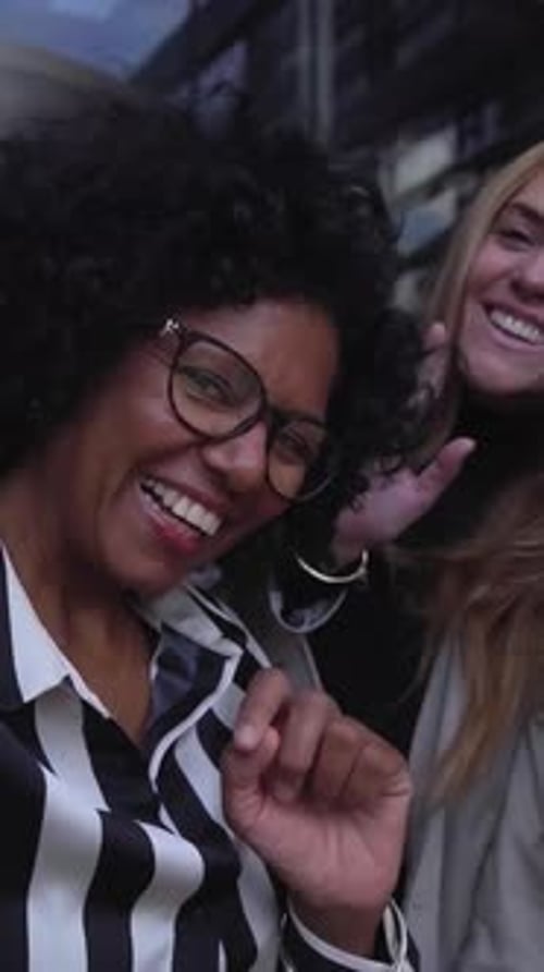 Two Smiling Women Outside of Building
