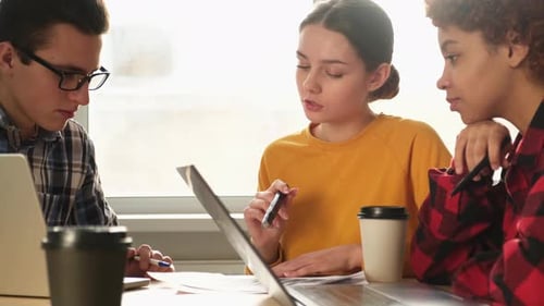 Young Adults Collaborating in a Modern Workplace
