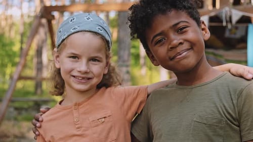 Two Boys Smiling at Camera in Woods