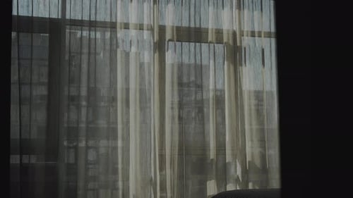 City View Through Apartment Window With Curtains