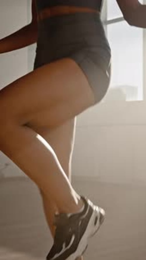 Athletic Woman Skipping Rope in Bright Sunny Room