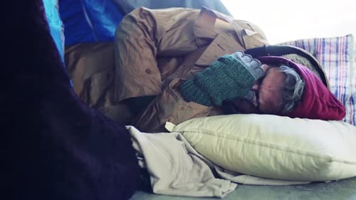 A Portrait of Homeless Beggar Man Lying Outdoors