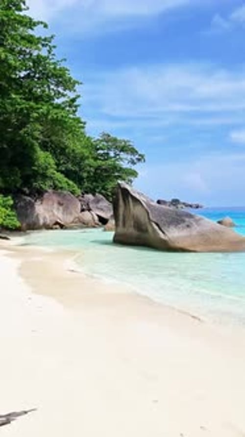 Quiet Ocean with a Boat Trees on Shore Under Cloudy Sky Similan Islands Thailand