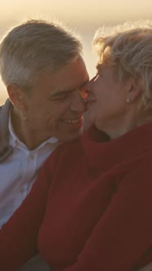 Senior Couple Sharing Intimate Moments at Sunset on Beach