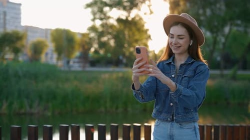 Young Woman on Video Call in Urban Park