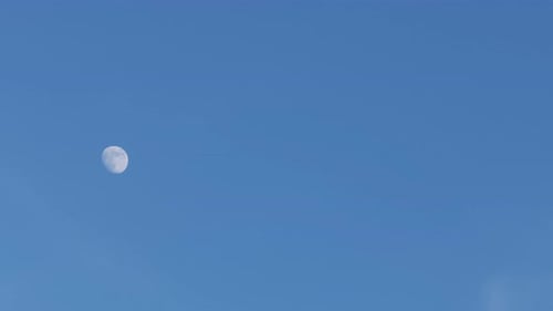 Crescent moon in the blue sky.