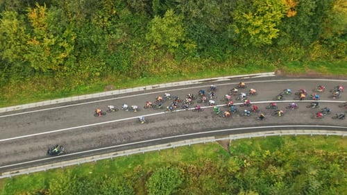 Close Up Aerial Drone View of People Riding Bicycles on Road Lots of Participants of Sports